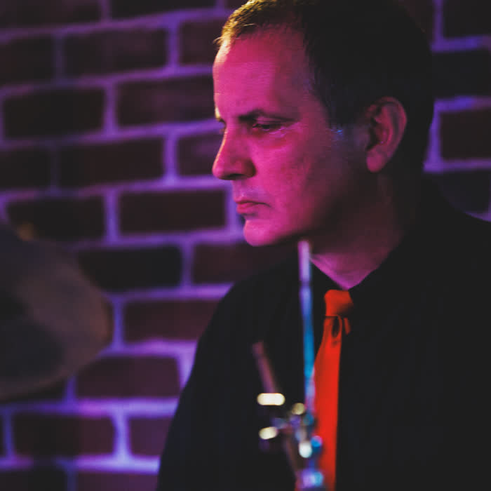Wayne Gierman in profile behind the cymbals