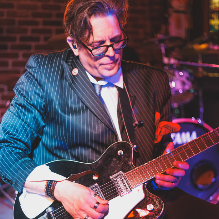 John Madeley playing his black Gretsch at John & Peter's